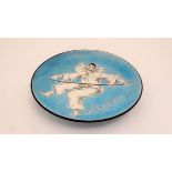 An early 20thC enamelled decorative dish depicting Pierrot holding a balancing stick on a crackle