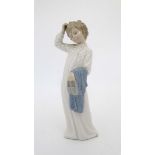 A Nao by Lladro figure Bedtime Boy depicting a boy in nightshirt holding slippers and towel.