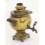 A late 19thC brass Russian samovar of pot belly form, the square base with 4 exb prize medallions
