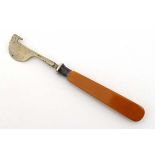 A nickel orange peeler with celluloid handle. Approx 5 1/3" long  CONDITION: Please Note -  we do