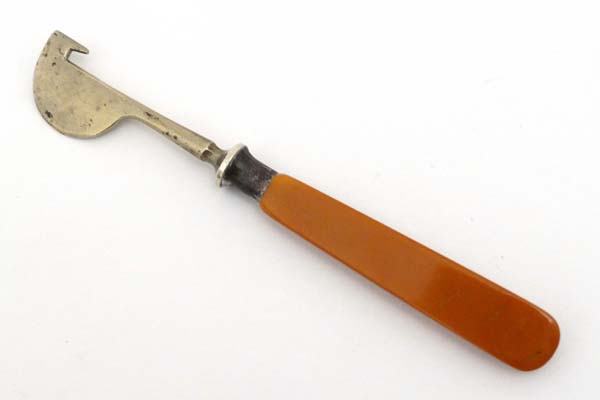 A nickel orange peeler with celluloid handle. Approx 5 1/3" long  CONDITION: Please Note -  we do - Image 2 of 3