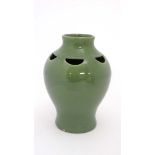 A Green C.H Brannam Ltd Barnstaple baluster vase. With impressed mark to base 10'' high.