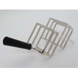 A 20thC Christopher Dresser style 4-slice toast rack of angled form. 10" long  CONDITION: Please