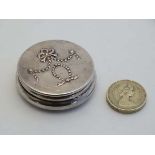 A silver small trinket / dressing table pot of circular form with bow and swag decoration to the