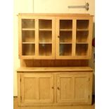 Pine dresser :a Victorian and later pine dresser with twin glazed doors opening before two