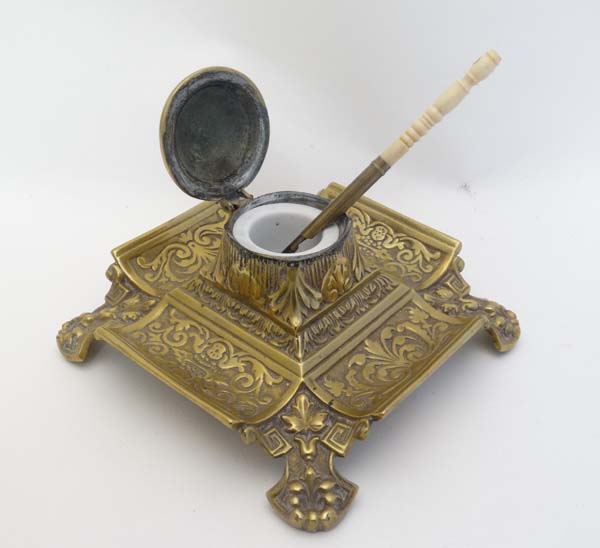 A Victorian cast brass inkwell / Standish of squared form with relief decoration having hinged - Image 6 of 7
