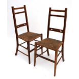 A pair of late 19thC oak Arts and Crafts envelope rush seated chairs with square tapering front legs