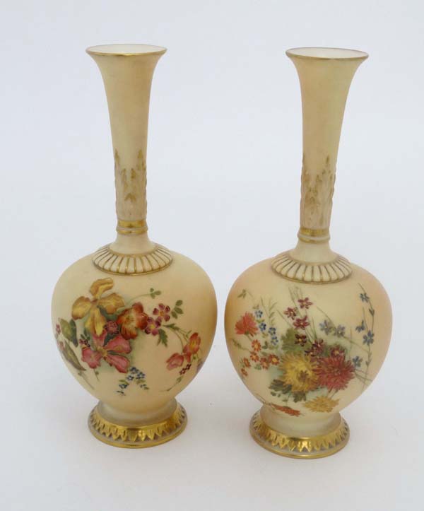 Two Royal Worcester blush ivory bottle vases, of globular form with high slender necks. Decorated