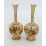 Two Royal Worcester blush ivory bottle vases, of globular form with high slender necks. Decorated