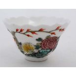 A small Chinese porcelain bowl in a famille-rose style. Decorated with images of Chrysanthemums