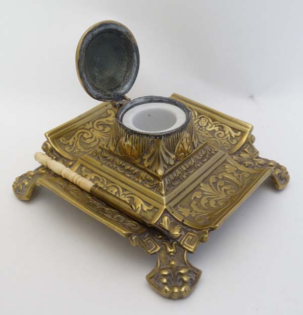 A Victorian cast brass inkwell / Standish of squared form with relief decoration having hinged - Image 5 of 7