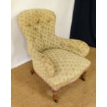 A Victorian button back low arm over stuffed chair with iron frame? and short golden oak legs. 34"