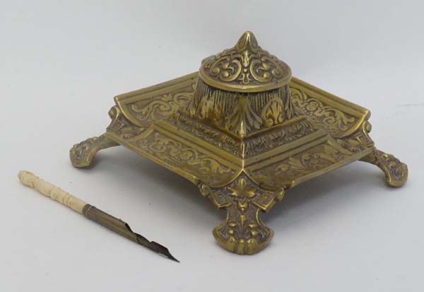 A Victorian cast brass inkwell / Standish of squared form with relief decoration having hinged - Image 3 of 7