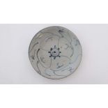 A small Chinese blue and white ceramic plate. Loosely decorated in an Oriental style. 5''