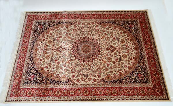 Carpet / rug :  a Keshan carpet with beige ground , black, red, and dark mustard colours , 95"x 62"