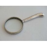 A magnifying glass with silver pistol grip handle  5" long CONDITION: Please Note -  we do not