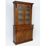 A Victorian burr walnut Secretaire Bookcase with  two glazed doors before 3 adjustable height