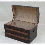 A 19thC banded dome top travel trunk with canvas steel and wood covering, twin carry handles and