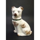 A 19thC small pottery figure of a seated dog decorated in brown with collar and sponged detail to