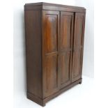 Early 20thC mahogany triple wardrobe, the right hand door opening to reveal  3 linen slides and