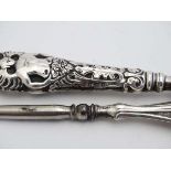 A silver handled shoe horn hallmarked Birmingham 1903 maker Crisford & Norris together with a silver