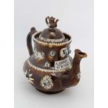 A 19thC large Bargeware / Measham teapot decorated with traditional design on a brown glazed body,