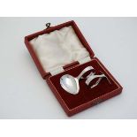 A cased christening set comprising spoon and pusher hallmarked Sheffield 1953 maker Oliver & Bower