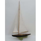 A large 19th C pond yacht. With metal keel with working articulated rudder. Fabric sails, string and