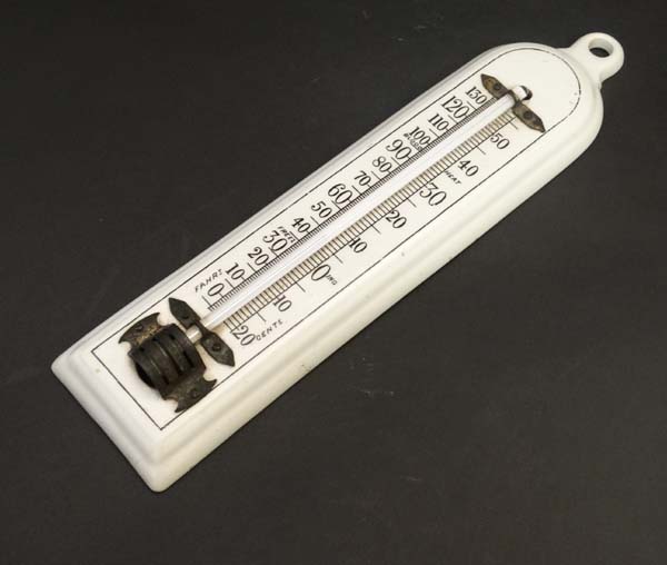An early 20thC ceramic mercury thermometer with Fahrenheit and Centigrade scales . 10 3/4" high
