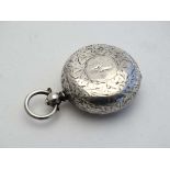 A silver sovereign case of pocket watch form with engraved acanthus decoration. Approx 1  1/8"