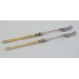 A pair of silver plate pickle forks with bone handles formed as deer hoofs approx 8 1/2"