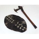 Native Tribal : an axe with blackened end to the cylindrical handle , cross hatched blackened