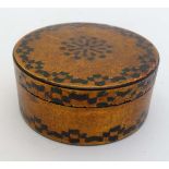 A Georgian circular lidded box with lacquered and faux straw work gilt and green detail.   3 1/2"