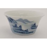 A small Chinese blue and white porcelain bowl. Decorated with an oriental landscape including