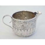A Victorian small silver cream jug  with embossed and fluted decoration. Hallmarked Birmingham