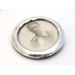 A silver photograph frame of circular form. Hallmarked Birmingham 1916. 2 1/2" diameter