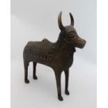 Antiquity : A hollow cast bronze image of a standing horned cow /  bovine with ornate head