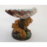 A rare George Jones Majolica comport in the form of a large shell on a pedestal, the base flanked by