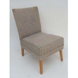 Vintage Retro : a contemporary 1950's style low squared form nursing chair with cloth upholstery and