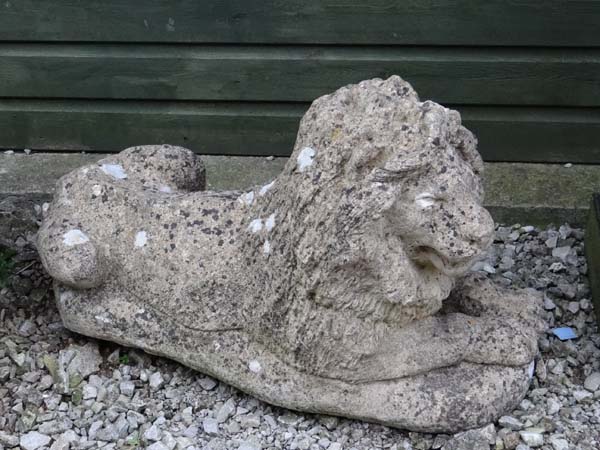 Garden and architectural : an old  composite stone figure of a couchant lion. Has two fixing holes