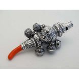 A white metal child's rattle with whistle to one end, bells and teether . Marked 800 . The whole 4
