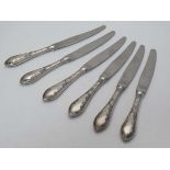 A set of 6 table knives with Continental .800 silver handles with floral and foliate decoration 8