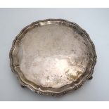 A Scottish silver salver on 4 scrolled feet with wavy edge . Hallmarked Edinburgh 1969 maker Garrard