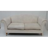 Laura Ashley c: A pair of damask silk cream uphosltered large 2-seat sofas with scroll arms and hump