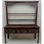 An 18thC and later oak 3-drawer dresser with open plate rack with pine lined drawers ( front to back