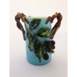 A c1900 polychrome Majolica cylindrical shaped pot having applied fruiting brambles on a turquoise