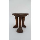 A Native Tribal African 3 legged Head Rest / stool made of carved wood, 7 1/2" high.
 CONDITION: