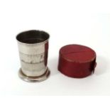 A red Morroco leather cased telescopic pedestal cup, extending to 2 1/2" high CONDITION: Please Note