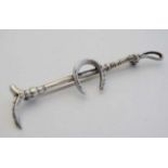 A silver bar brooch / stock pin formed as a riding crop with horse shoe to centre .  2 3/4" wide