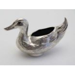 A silver novelty pin cushion formed as a duck with black velvet cushion to back. Hallmarked